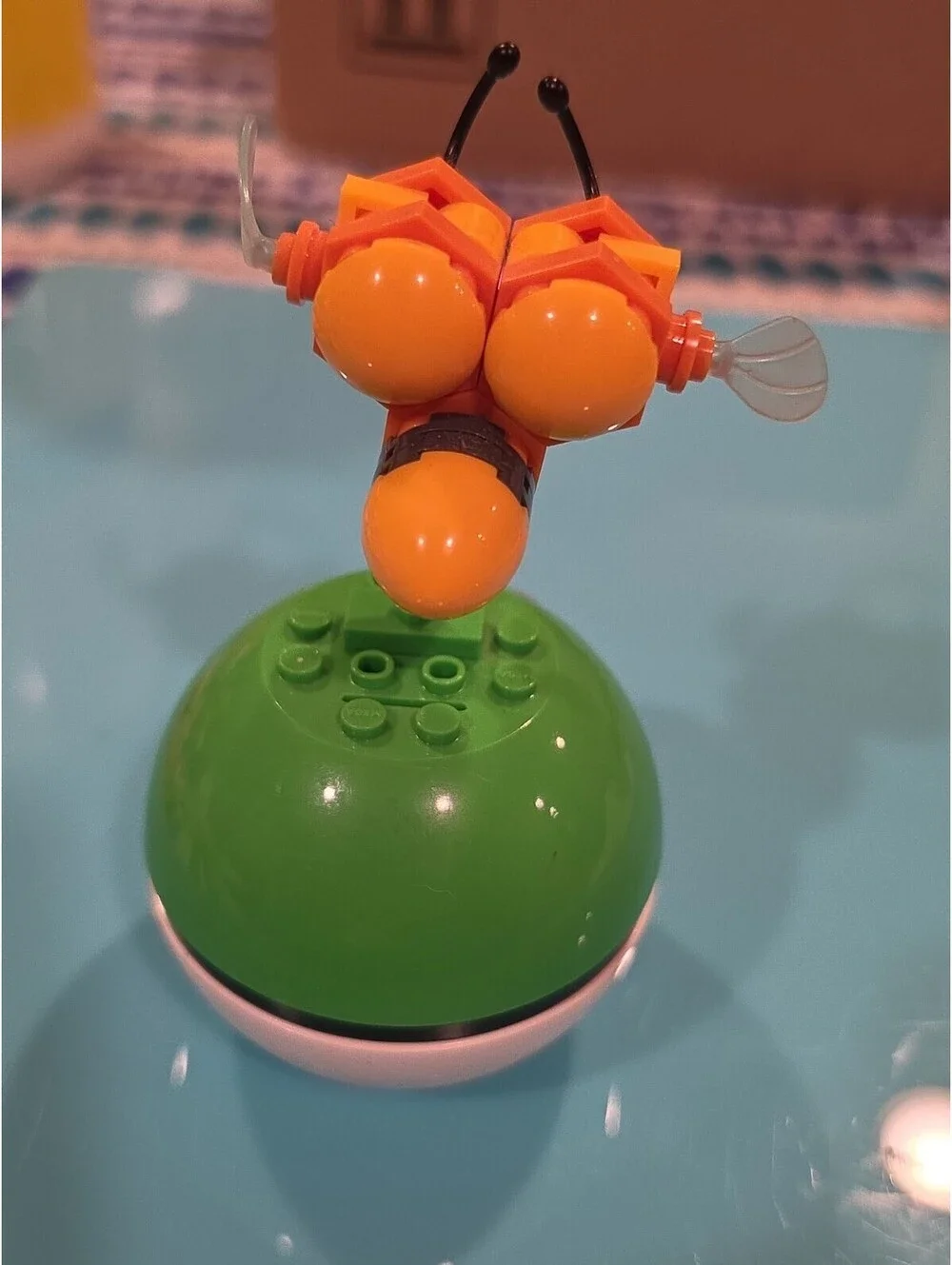 Pokémon Combee Plastic Figure on Green Poké Ball Base, Yellow/Black/Orange